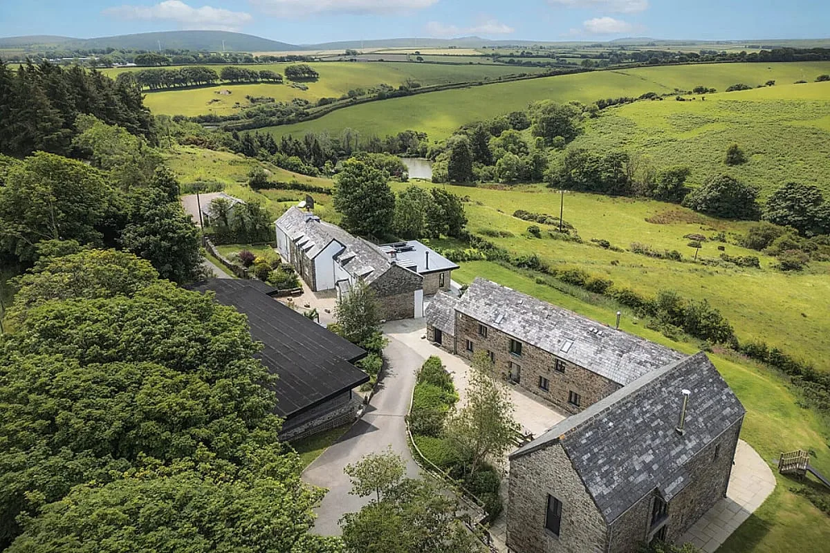 Aerial view of the Tregulland estate near Launceston, stone barns in a valley on the edge of Bodmin Moor